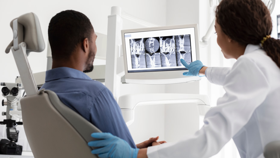 dentist discussing x-rays with patient
