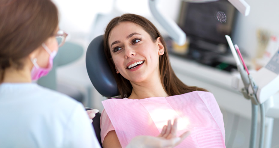 dentist talking to a patient about dental care