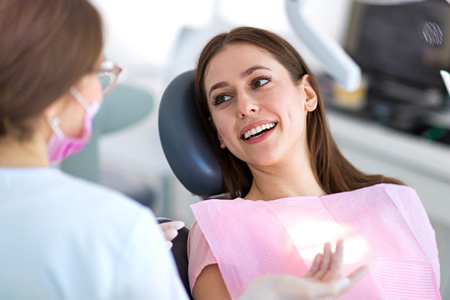 dental hygienist with patient in chair