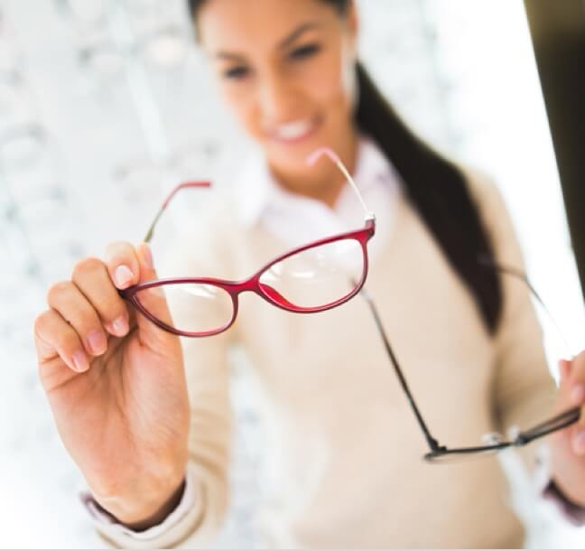 A woman looking at glasses