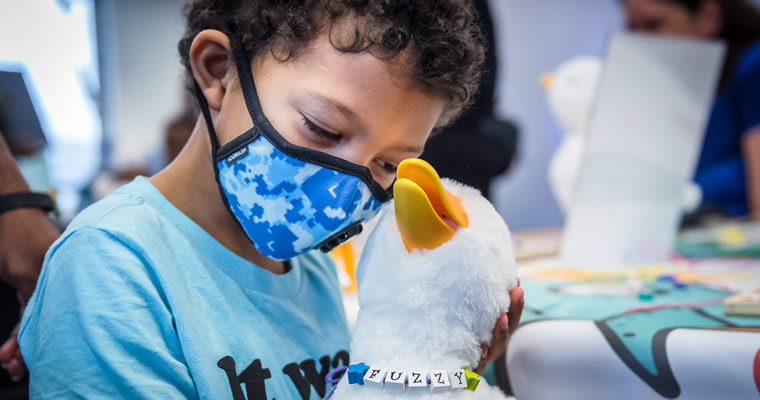 Child holding My Special Aflac Duck.