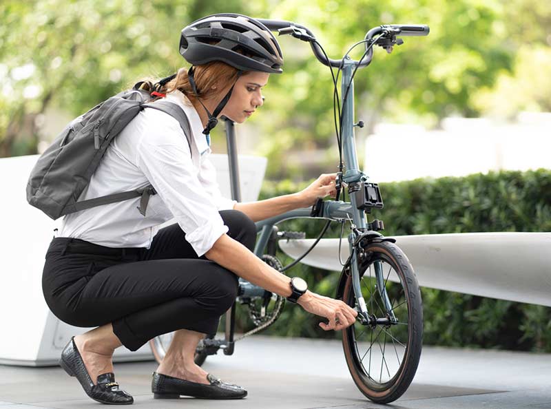woman unlocking her bicycle