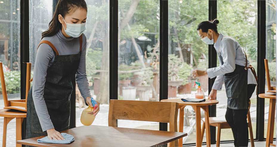 waiters bussing tables in restaurant