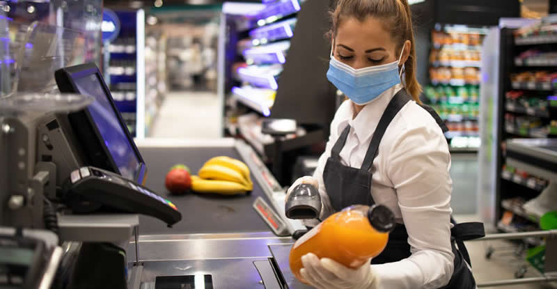 grocery store cashier scanning orange juice