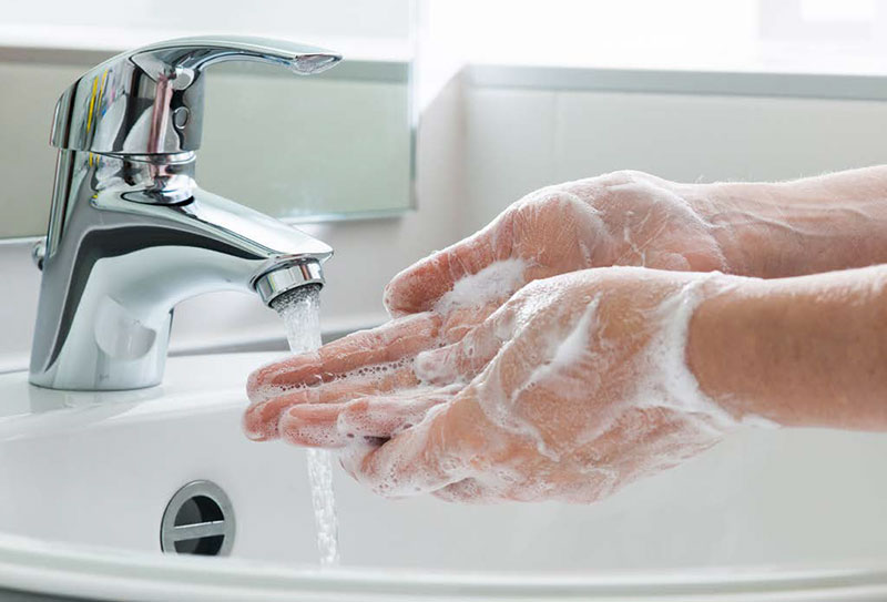 washing hands in sink