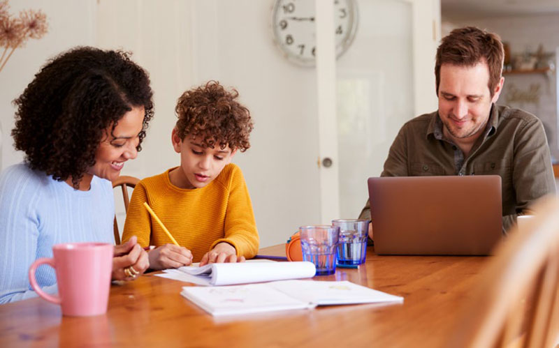 family sitting at table working together