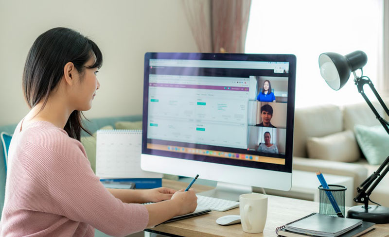 woman working while on a web meeting