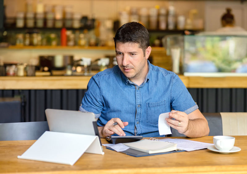 business owner using a computer to track expenses
