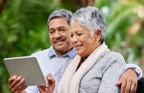 a man and a womman using a digital tablet device