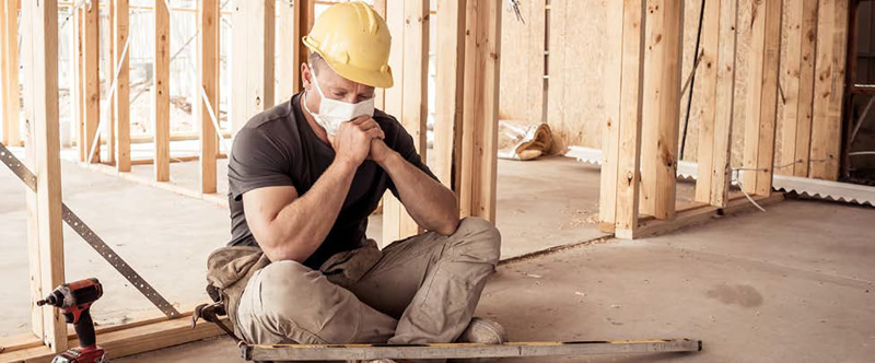 home builder sitting on the floor in deep thought