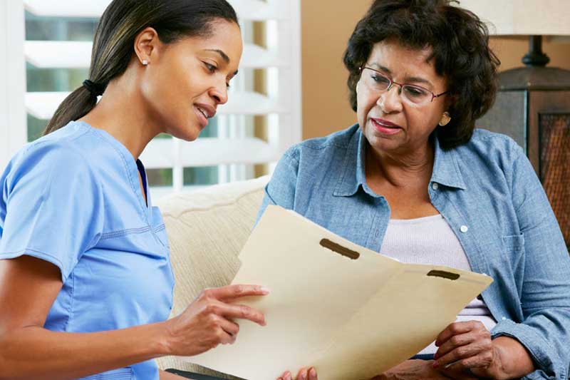 nurse looking at folder with patient