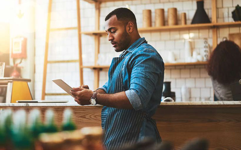 small business owner looking down at tablet