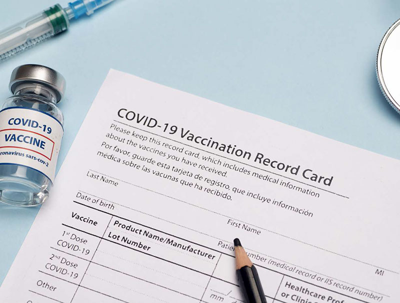 Covid-19 vaccination card and vaccine vile
