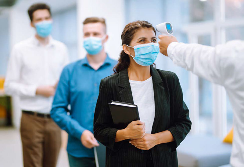 woman getting a forehead temperature check