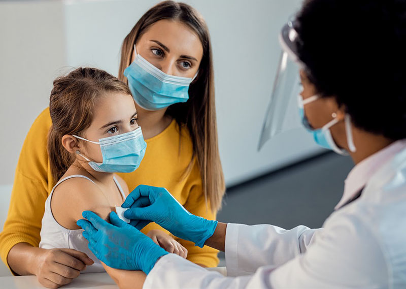 mother holding daughter prepare for an arm injection