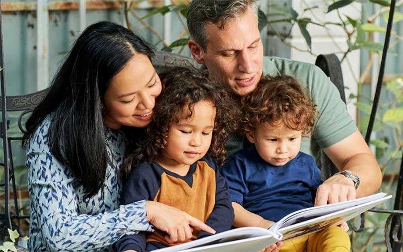 family reading a book together