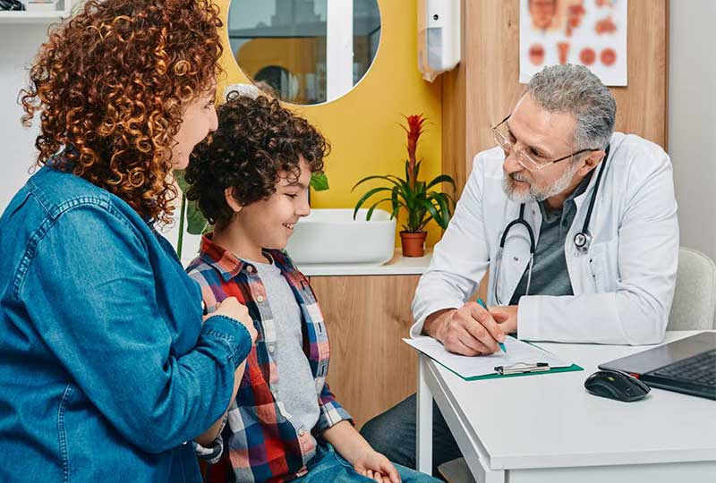 mother and son talking to doctor