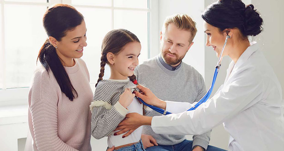 family standing next to little girl in hospital bed