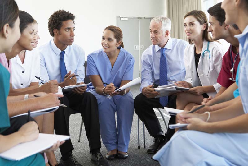 medical professionals talking in a circle