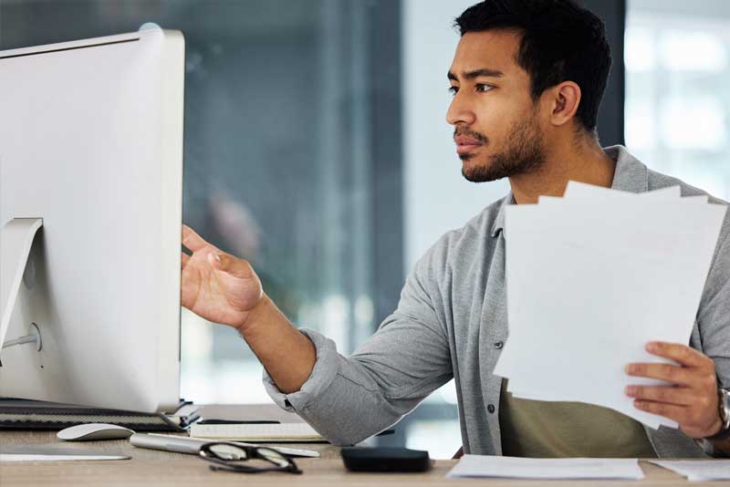 man working and holding papers