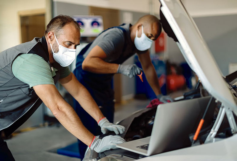 mechanics working on vehicle