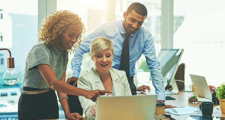 coworkers looking at laptop together