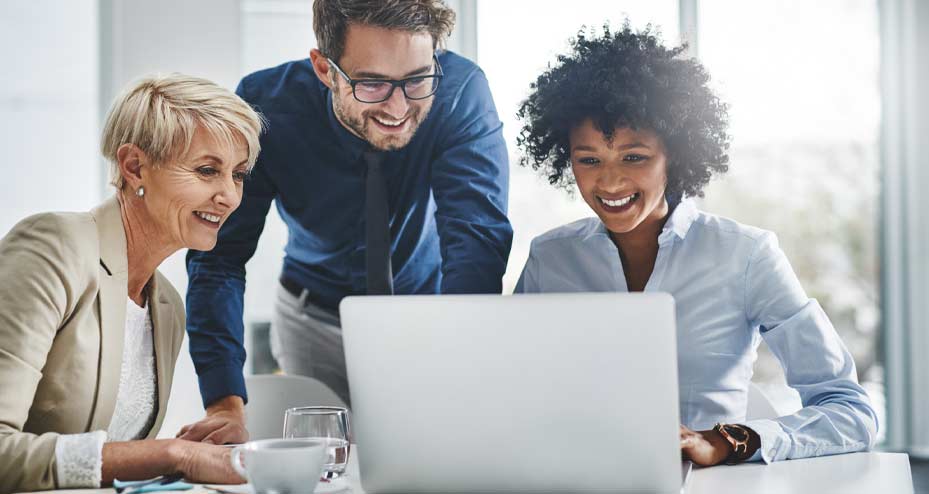 coworkers looking at laptop