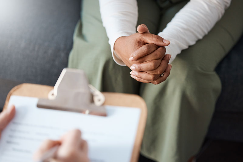 person's hands and a clipboard