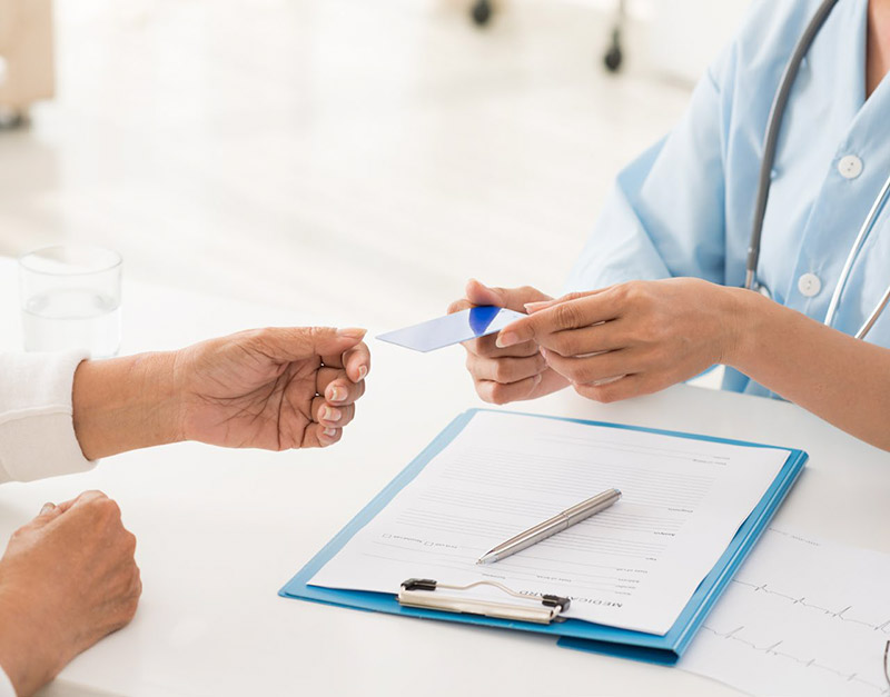 person handing card to another person