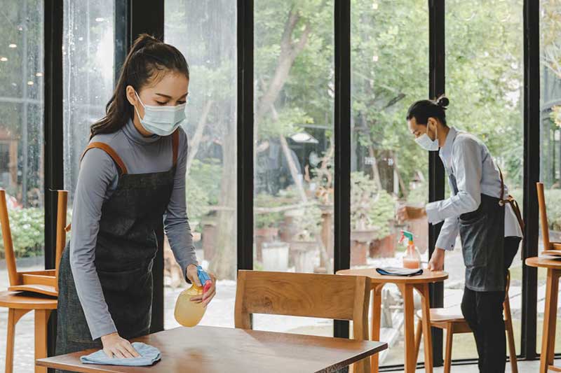 servers cleaning tables in a restaurant