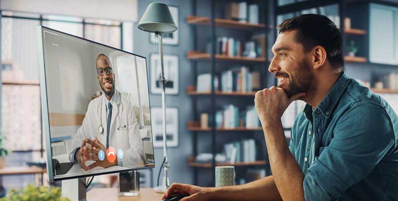 man talking with doctor through telehealth