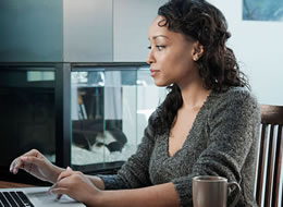woman at table using laptop