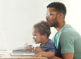 man and son using a laptop
