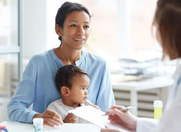 woman with child speaking with a doctor