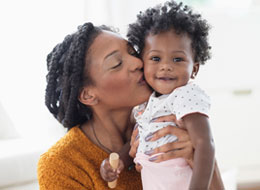 mother kissing baby