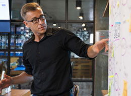 Man pointing to white board