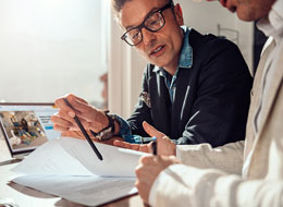 two men looking at paperwork