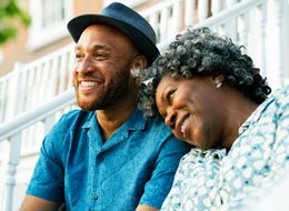 two family members sitting outside on porch