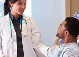 doctor and patient looking at one another in hospital