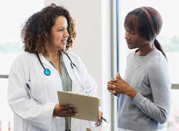 doctor and patient looking at clipboard