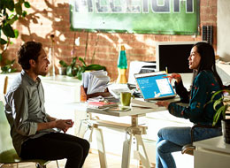 two employees sitting and talking