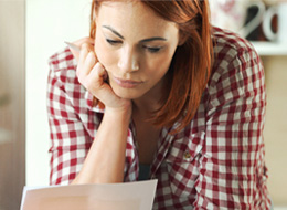 woman looking down at paper