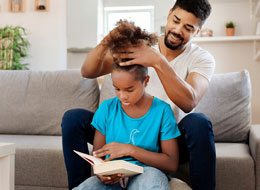 father working on daughters hair