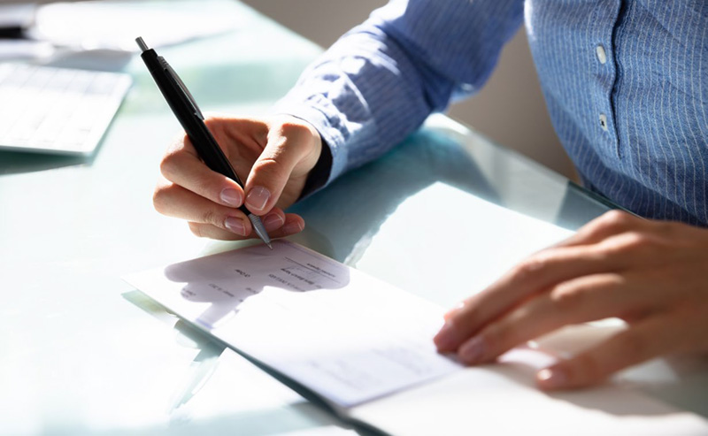 person writing a check