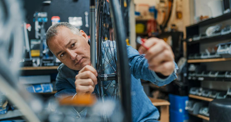 man repairing bicycle