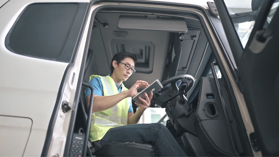 man in a truck looking at a mobile device
