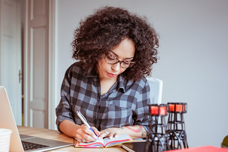 business owner writing in a notebook