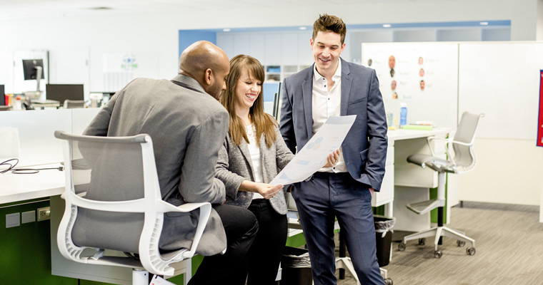 employees discussing a document or design