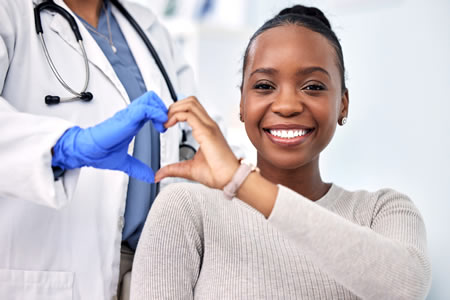 patient and doctor making a hand heart