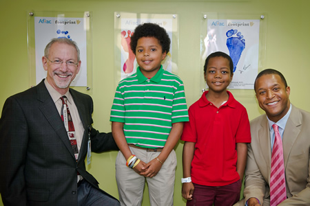 contributors pictured in with footprint awards wall